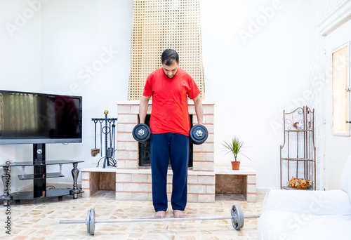 Athletic guy training hard at his home