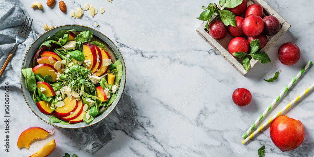 Fresh summer salad with peach, spinach, micro greens, feta cheese and almonds on light marble background. Healthy food, clean eating, Buddha bowl salad, top view Fresh summer salad with peach, spinach, micro greens, feta cheese and almonds on light marble background. Healthy food, clean eating, Buddha bowl salad, top view