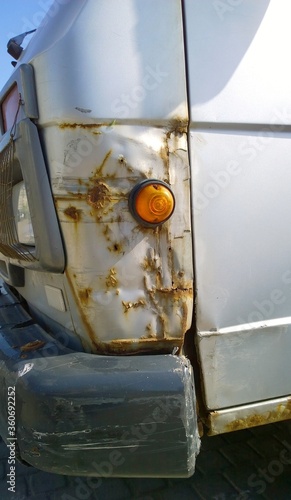 Truck with rust, corrosion, defects and scratches, close up. Car body repair. Sheet metal corrosion. Old steel surface. Vehicle bodywork. Auto service concept. Remove corroded surface. Damaged texture