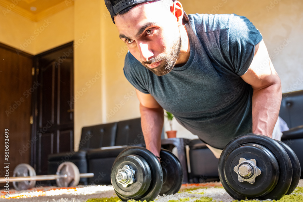 Guy doing some training at home to keep in good shape Guy doing some training at home to keep in good shape
