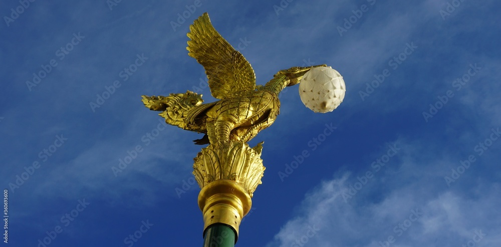 Looking at the cement  electric pole  head of a swan