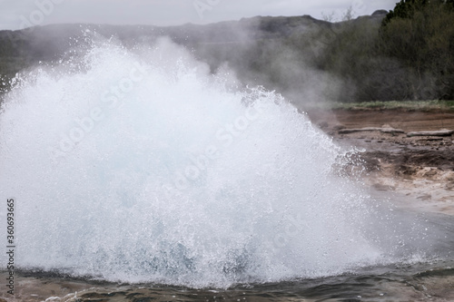Geysir in Iceland bubbles up with boiling hot water. A natural phenomenon