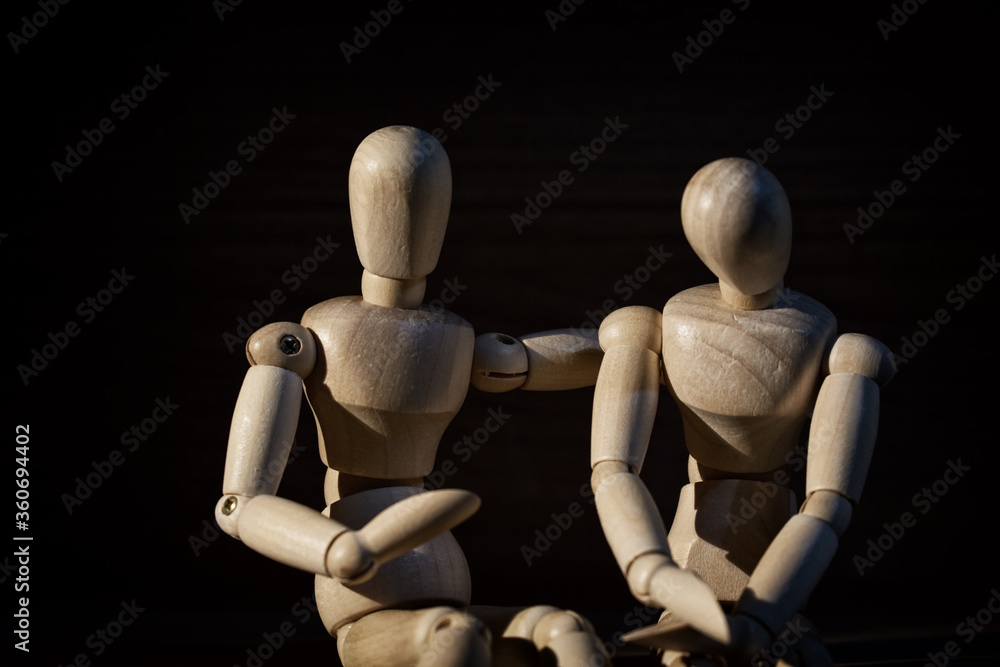 Wooden mannequin, Concern and worry of friend. Mental health, PTSD and suicide prevention. Post-traumatic stress disorder. Wooden mannequin, Concern and worry of friend. Mental health, PTSD and suicide prevention. Post-traumatic stress disorder.