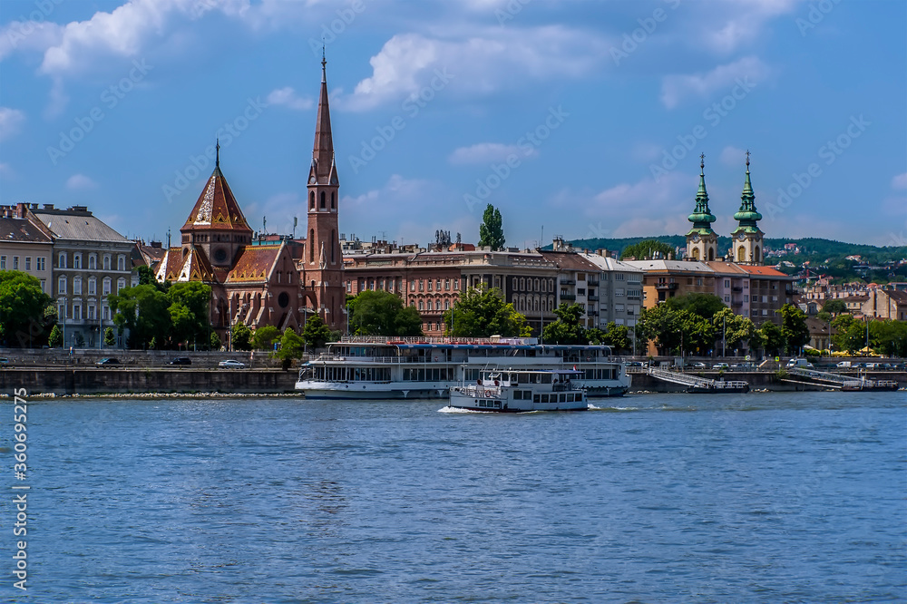 A view of the west bank of the River Danube in Budapest from a boat on the river during summertime