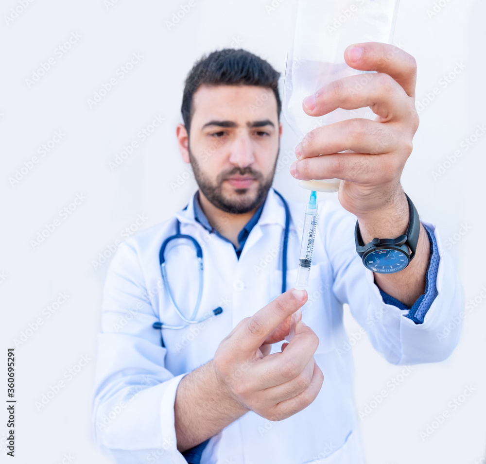 Arabic doctor holding needle in his hand Arabic doctor holding needle in his hand