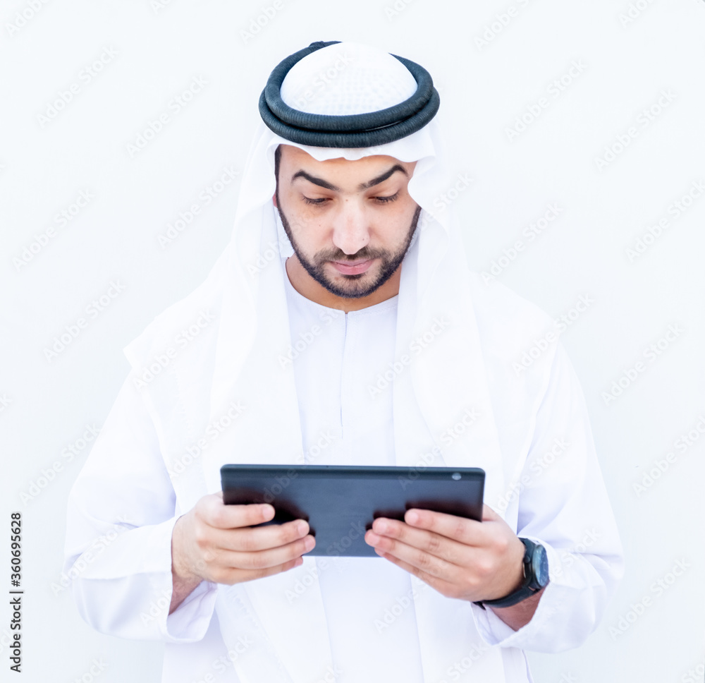 Arabic muslimman using tablet to study his lessons at school Arabic muslimman using tablet to study his lessons at school