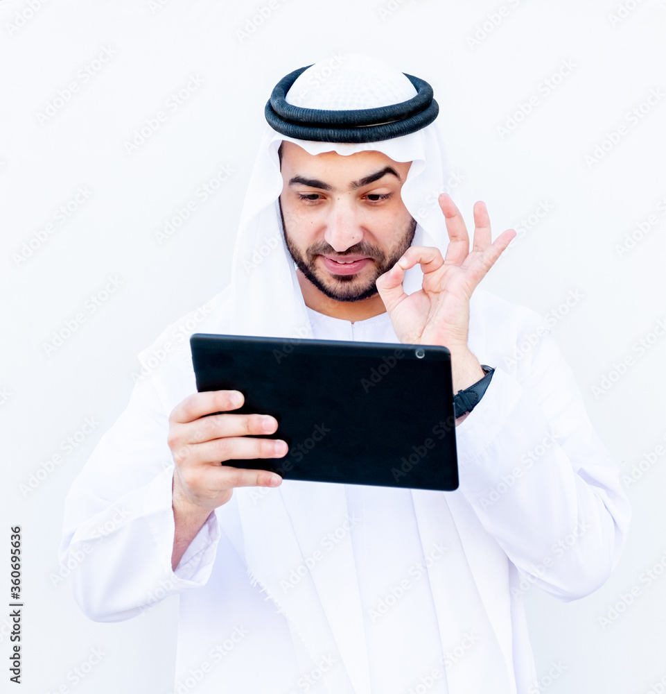 Arabic muslimman using tablet to study his lessons at school Arabic muslimman using tablet to study his lessons at school