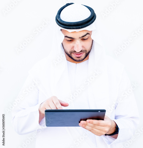 Arabic muslimman using tablet to study his lessons at school photo