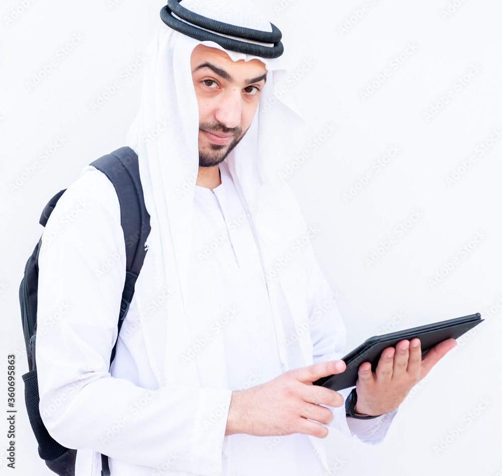 Arabic muslimman using tablet to study his lessons at school Arabic muslimman using tablet to study his lessons at school