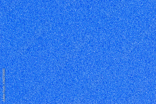 A macro photo of a blue gradient color with texture from real foam sponge paper for background, backdrop or design.