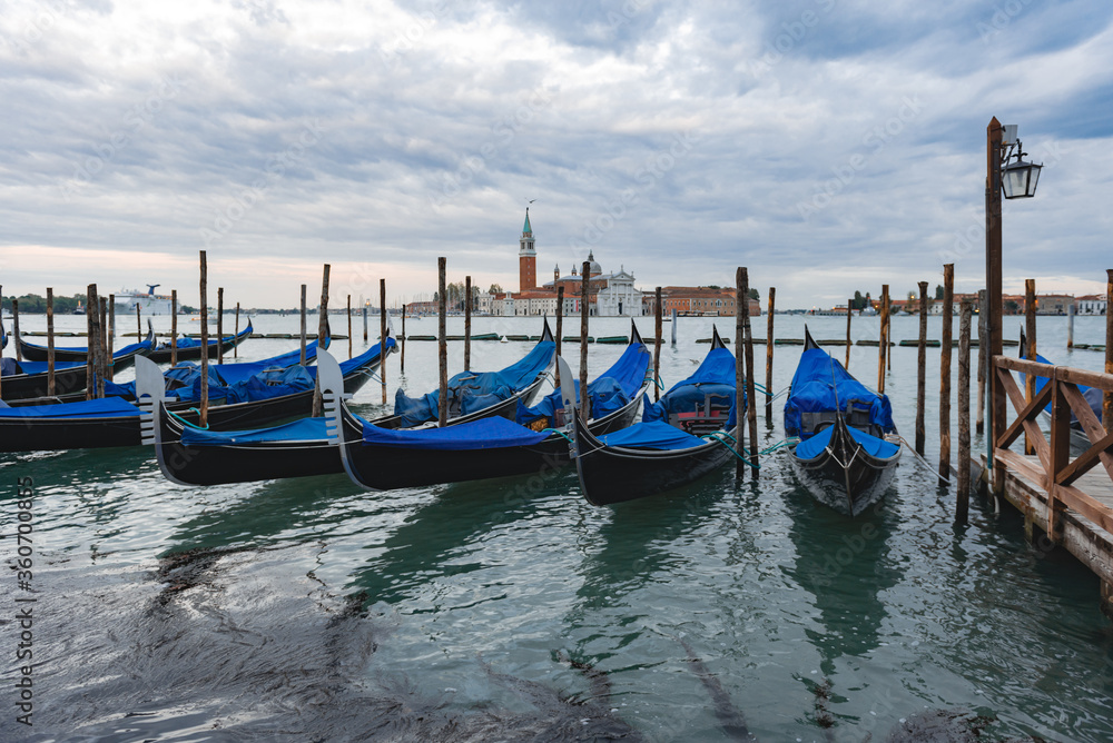 Gondolas anchored by Piazza San Marco with San Giorgio di Maggiore church in Venice,