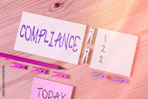 Word writing text Compliance. Business photo showcasing the action or fact of complying with a wish or commands Colored clothespin papers empty reminder wooden floor background office photo