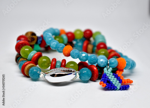 A group of colorfull bracelets on a white background