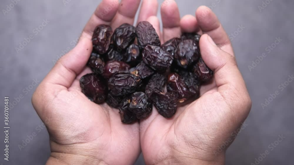high angle view of date fruit on palm of hand. high angle view of date fruit on palm of hand.