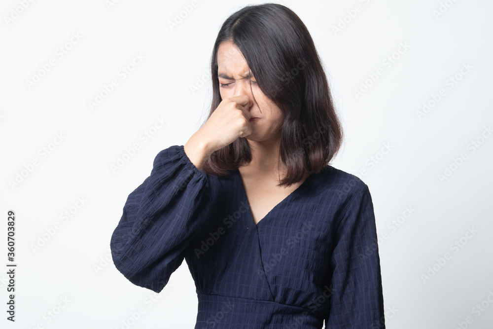 Young Asian woman holding her nose because of a bad smell. Young Asian woman holding her nose because of a bad smell.