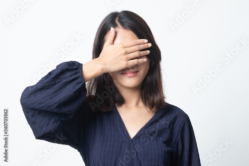 Young Asian woman close her eyes with hand. © halfbottle