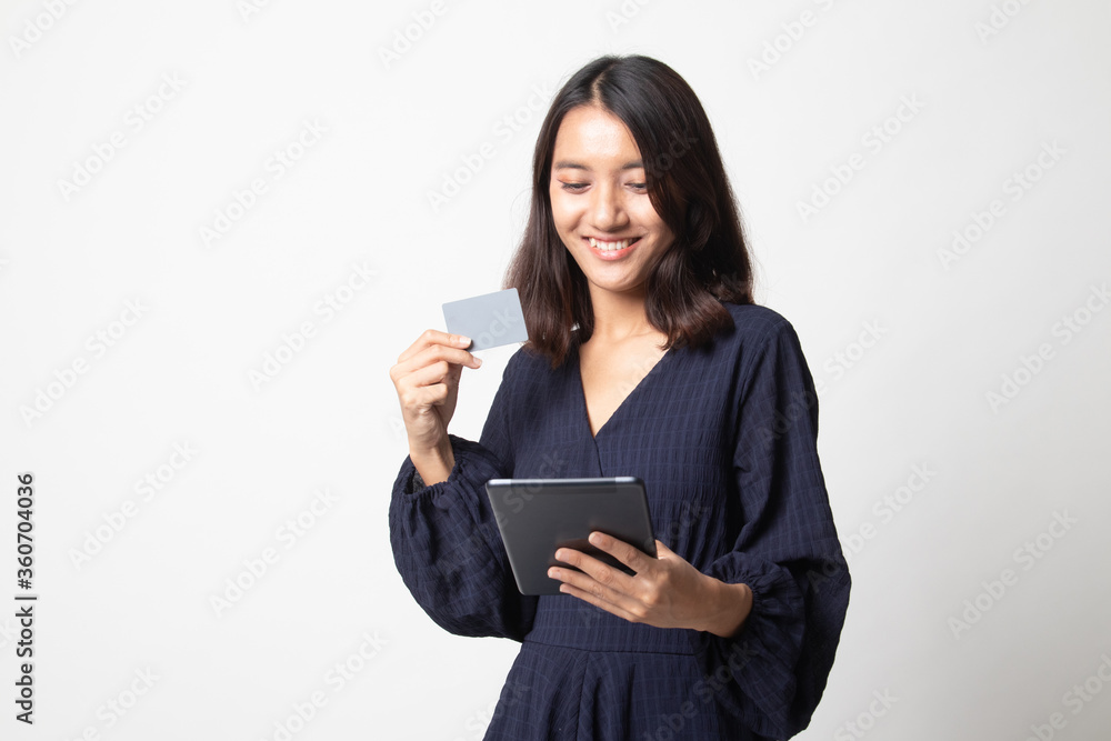 Young Asian woman is shopping online with credit card and tablet. Young Asian woman is shopping online with credit card and tablet.