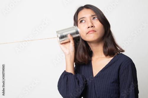 Young Asian woman with tin can phone.