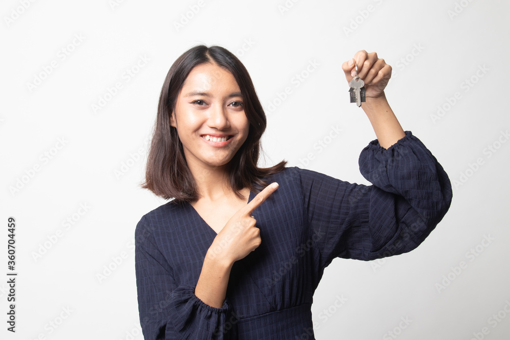 Cute asian girl showing home residence keys. Cute asian girl showing home residence keys.