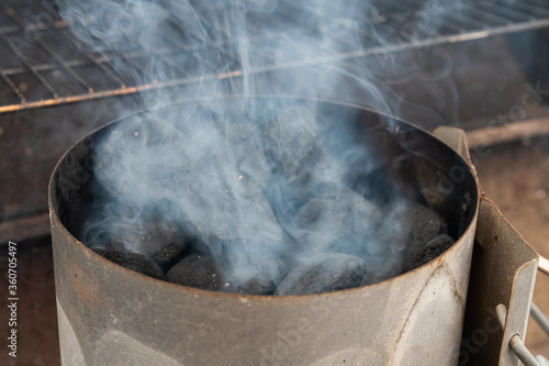Smoke billowing from chimney charcoal starter