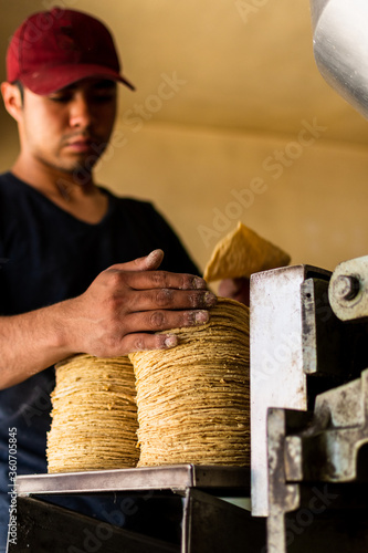 young man selling tortillas of nixtamal