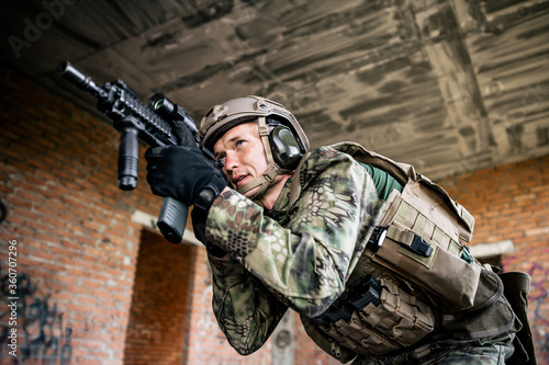 One soldier with a weapon aims the scope at the opponents. Wartime. Service in army