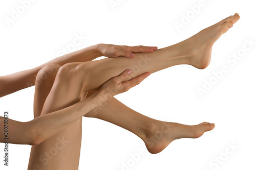 A young girl touching her silky skin on her legs after depilation
