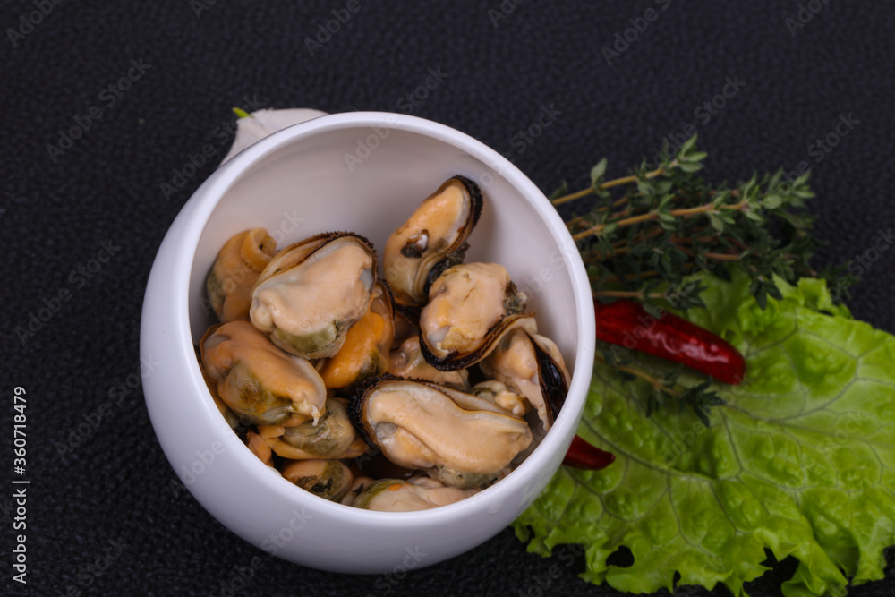 Pickled mussels in the bowl served pepper, garlic and salad Pickled mussels in the bowl served pepper, garlic and salad