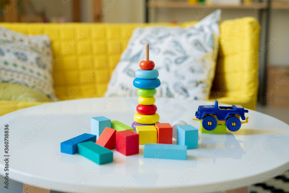 Large group of small wooden cubes of various colors and plastic lorry on table Large group of small wooden cubes of various colors and plastic lorry on table