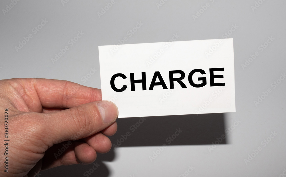 Message on the card CHARGE, in hands of businessman. Message on the card CHARGE, in hands of businessman.