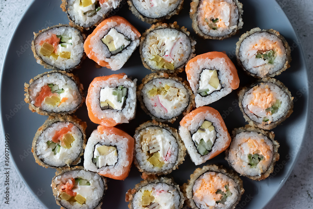 Assorted sushi on a gray plate. Close-up. Assorted sushi on a gray plate. Close-up.