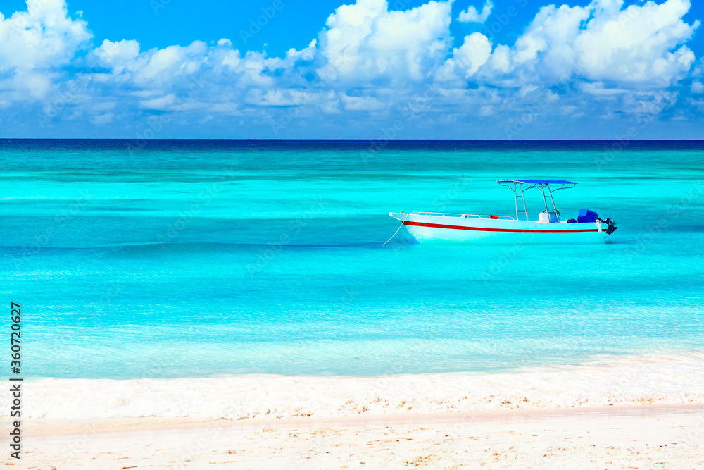 Boat and beautiful blue ocean and beach with white sand coast. Summer vacation travel background