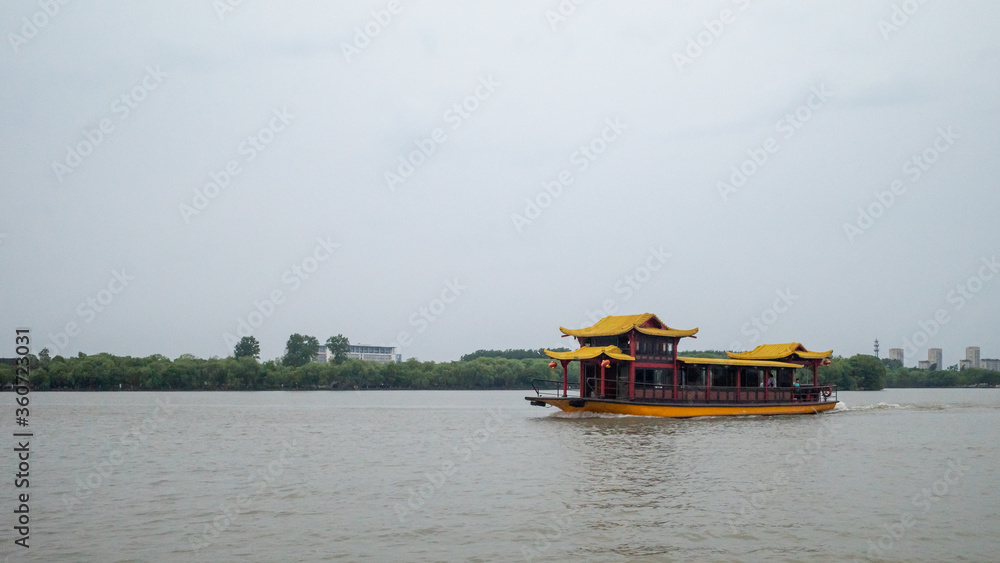 Traditional boat traveling on South Lake in Jiaxing, China