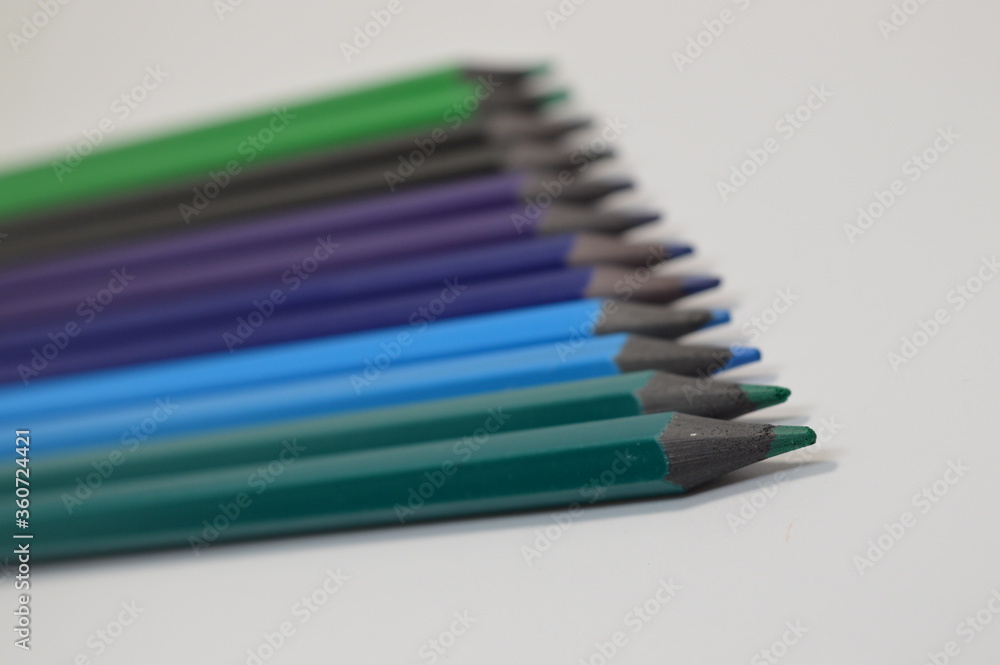 Naklejka premium Colored wooden pencils on a white background