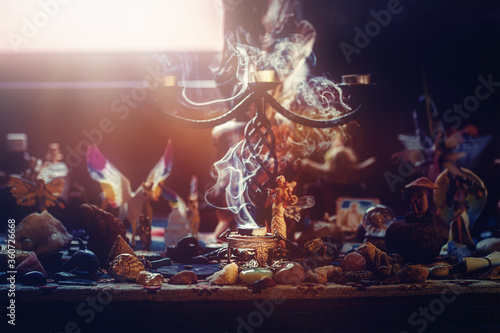 incense in a woman hand, incense smoke on a black background.