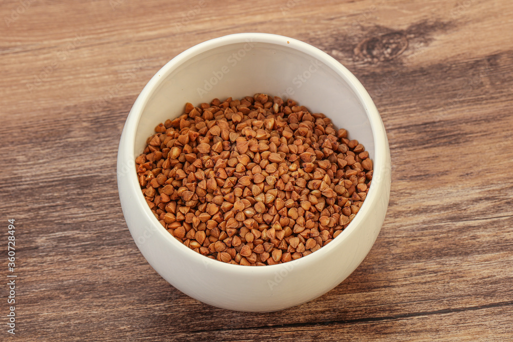 Raw buсkwheat cereal in the bowl Raw buсkwheat cereal in the bowl