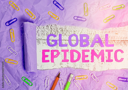 Text sign showing Global Epidemic. Business photo text a rapid spread of a communicable disease over a wide geographic area Rolled ripped torn cardboard placed above a wooden classic table backdrop photo