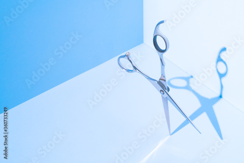 Stylish Professional Barber Scissors, Hairdresser salon concept, Haircut accessories. Flying hairdresser tools scissors under trendy color background with copy space and hard light.