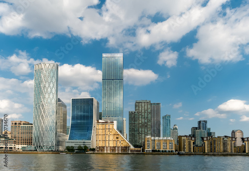 Tall modern buildings of Canary Wharf area of London on the riverside of Thames