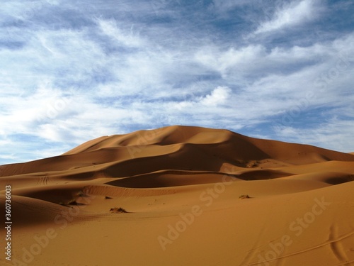 Sand dunes of Erg Chebbi under blue sky with white clouds, Morocco