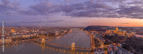 Panoramic aerial drone shot of Buda castle on hill Chain Bridge during Budapest sunset hour