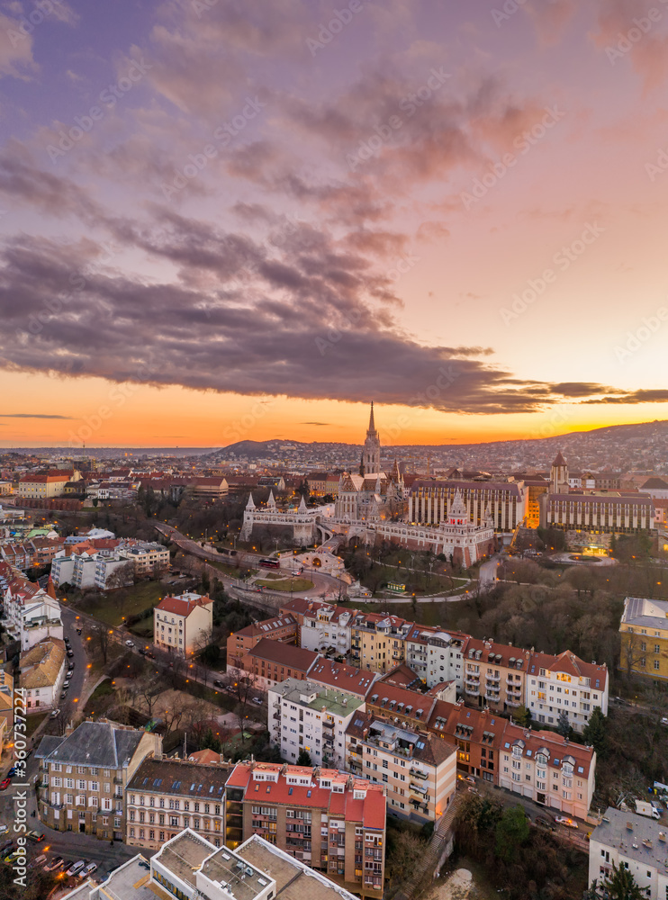 Aerial drone shot of Matthias Church Fisherman's Bastion on Buda Hill in Budapest sunset time