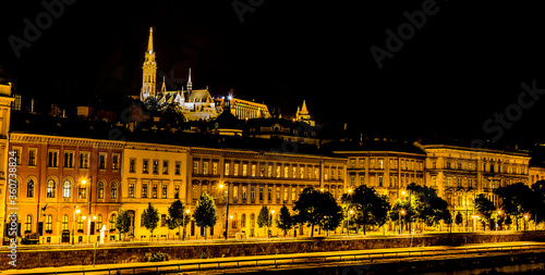 A view from the Chain Bridge across the River Danube in Budapest towards the Fisherman's Bastion at night in the summertime