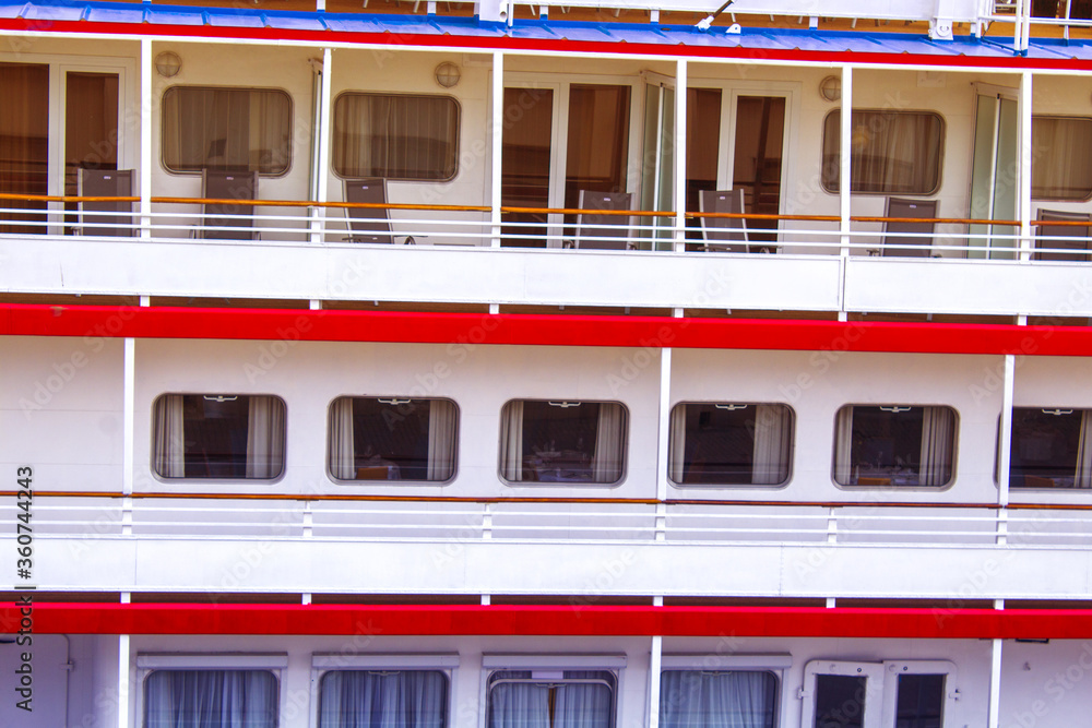Closeup view of a huge cruise ship. Balconies and chairs. a series of hundreds of rooms on a cruise ship Closeup view of a huge cruise ship. Balconies and chairs. a series of hundreds of rooms on a cruise ship