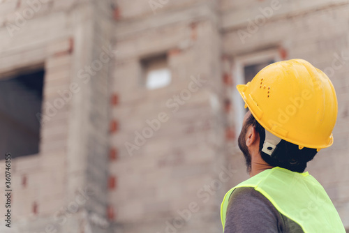 Young man architect on a building construction site
