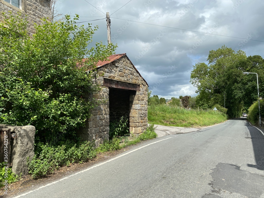 Empty stone farm building, with weeds, and cart track in, Kildwick, Keighley, UK