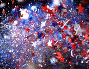 Background of red, white, and blue sparkling glitter scattered with shiny stars confetti. 4th of July celebration background.