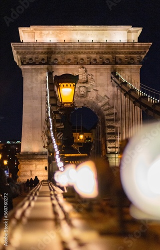 Beautiful SzÃ©chenyi Chain Bridge situated on the river Danube in Hungary shining at night photo