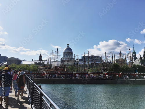 Montreal, Quebec / Canada August 24th 2019: summer time at the bank of Saint Laurent river with Bonsecours market in the old port in the background photo