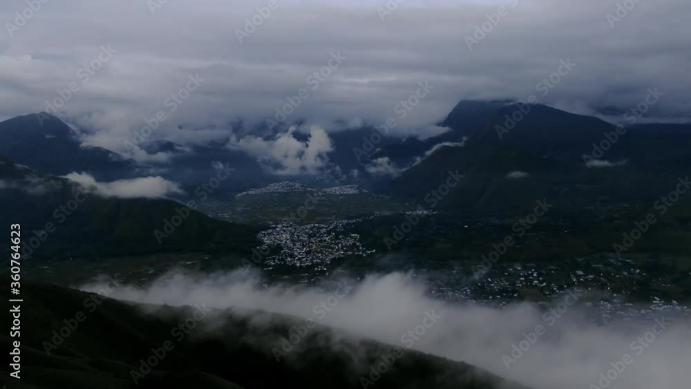 Aerial View Moving shot, Above the mist on Pergasingan Hill, Sembalun Village and clouds in the background. Aerial View Moving shot, Above the mist on Pergasingan Hill, Sembalun Village and clouds in the background.